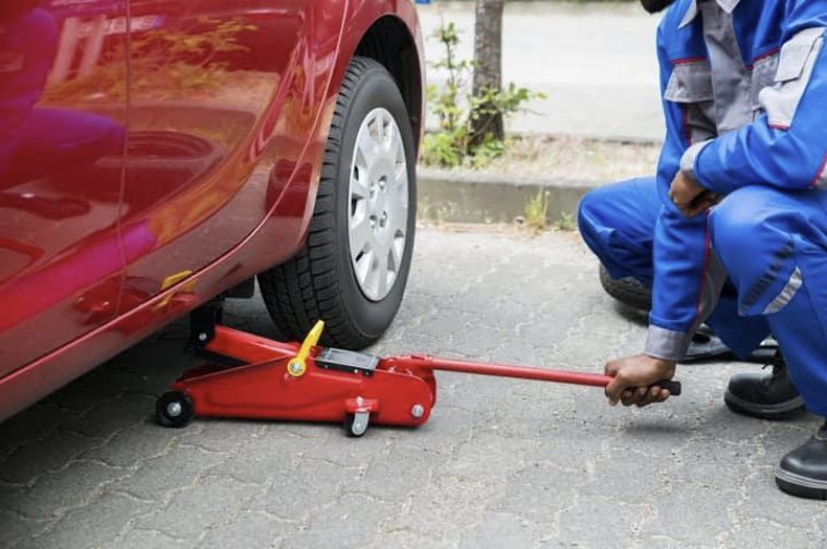 Figure 2: Image of a car jack being used to lift a car (Source: Holts)